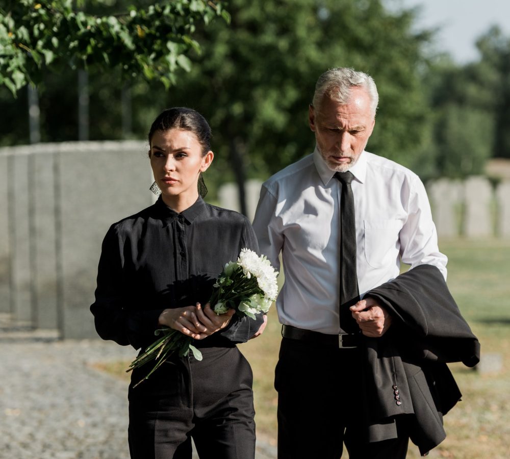 handsome-senior-man-standing-with-attractive-woman-holding-flowers-on-funeral.jpg handsome-senior-man-standing-with-attractive-woman-holding-flowers-on-funeral.jpg