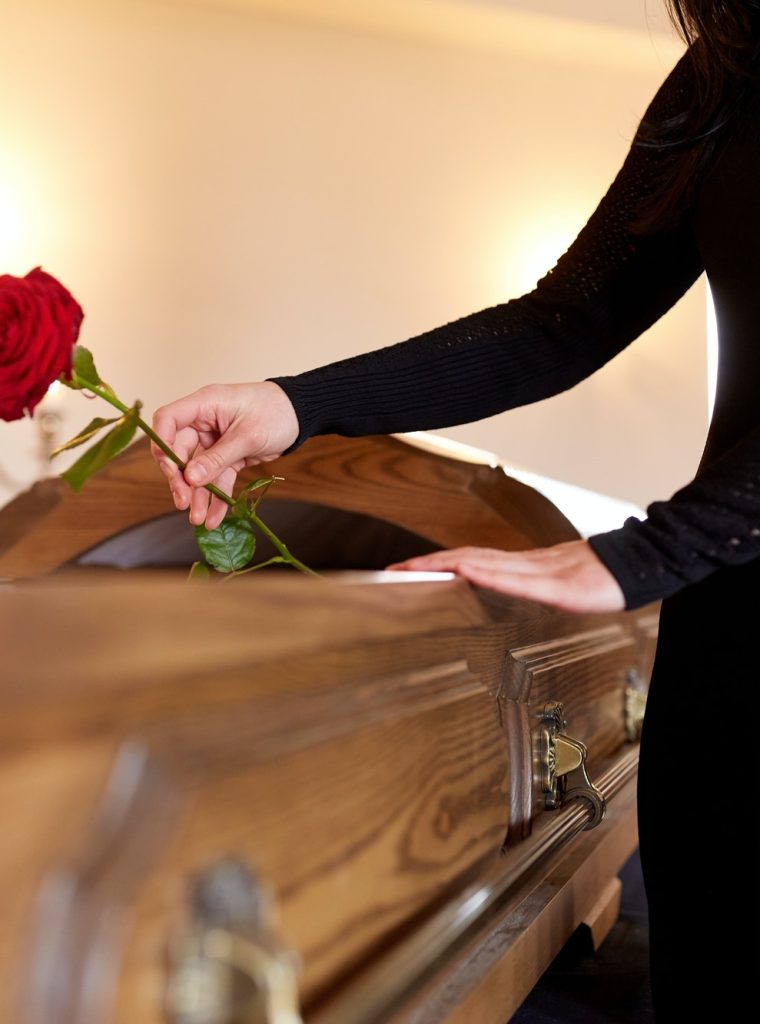 woman-with-red-roses-and-coffin-at-funeral.jpg woman-with-red-roses-and-coffin-at-funeral.jpg